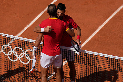 Novak Djokovic hugs Rafael Nadal